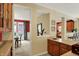 This image shows a pass-through with wood cabinets and light countertops to an adjacent space with a dining table at 4704 Pearcrest Way, Greenwood, IN 46143