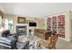 Inviting living room features a fireplace, built-in bookcase, and comfortable seating at 4704 Pearcrest Way, Greenwood, IN 46143