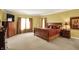 Spacious main bedroom with a large bed, dresser, and en-suite bathroom at 4704 Pearcrest Way, Greenwood, IN 46143