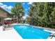 Inviting backyard pool with water features, lounge chairs, and lush landscaping provides an excellent area for outdoor relaxation at 4704 Pearcrest Way, Greenwood, IN 46143