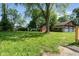 A grassy backyard featuring a storage shed and a detached garage at 4904 E 14Th St, Indianapolis, IN 46201