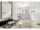This bathroom offers a tub and shower combination and classic fixtures at 4904 E 14Th St, Indianapolis, IN 46201