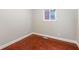 Bright bedroom with hardwood floors, a window, and fresh white trim at 4904 E 14Th St, Indianapolis, IN 46201