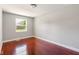 Bright bedroom with hardwood floors and a large window overlooking the outdoors at 4904 E 14Th St, Indianapolis, IN 46201