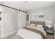 Cozy bedroom with neutral decor, barn door closet, and ample natural light at 4904 E 14Th St, Indianapolis, IN 46201