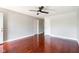 Spacious bedroom with dark hardwood floors, a ceiling fan, and ample natural light at 4904 E 14Th St, Indianapolis, IN 46201