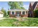 Charming brick house with a well-maintained lawn and inviting front entrance at 4904 E 14Th St, Indianapolis, IN 46201
