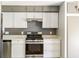 An updated kitchen featuring gray and white cabinets and stainless steel appliances at 4904 E 14Th St, Indianapolis, IN 46201
