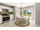 Bright kitchen features white cabinets, stainless steel appliances, and a cozy breakfast nook at 4904 E 14Th St, Indianapolis, IN 46201