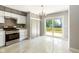 A spacious updated kitchen leading to a sliding glass door and outdoor deck at 4904 E 14Th St, Indianapolis, IN 46201