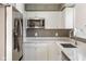This updated kitchen features white cabinets, stainless steel appliances, and quartz countertops at 4904 E 14Th St, Indianapolis, IN 46201
