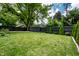 A serene backyard with lush green grass, a dark privacy fence, and a charming shed at 5660 Crittenden Ave, Indianapolis, IN 46220
