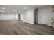 Spacious finished basement with light gray wood floors and recessed lighting throughout the open space at 5660 Crittenden Ave, Indianapolis, IN 46220