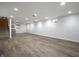 Finished basement with vinyl plank flooring, neutral walls, and recessed lighting at 5660 Crittenden Ave, Indianapolis, IN 46220