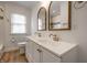 Charming bathroom with a double vanity, modern fixtures, and wood-look flooring at 5660 Crittenden Ave, Indianapolis, IN 46220