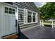 Close up of the gray home's front door and black porch deck and white railing at 5660 Crittenden Ave, Indianapolis, IN 46220