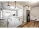 Open kitchen boasts marble countertops and a breakfast bar that overlooks the living area at 5660 Crittenden Ave, Indianapolis, IN 46220