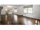 Bright, empty living room featuring gleaming hardwood floors and open access to the adjacent kitchen at 5660 Crittenden Ave, Indianapolis, IN 46220