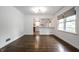Hardwood floors, crisp white walls, and open layout define this inviting living space with partial kitchen view at 5660 Crittenden Ave, Indianapolis, IN 46220