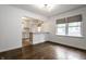 Open living space featuring hardwood floors and an adjacent kitchen with a convenient breakfast bar at 5660 Crittenden Ave, Indianapolis, IN 46220