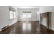 Bright and spacious living room showcasing hardwood floors, a fireplace, and ample natural light at 5660 Crittenden Ave, Indianapolis, IN 46220