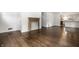 Clean, open-concept living room featuring a decorative fireplace and hardwood floors at 5660 Crittenden Ave, Indianapolis, IN 46220