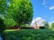 Residential home and backyard featuring a privacy fence, mature trees, and manicured lawn at 6118 Yellow Birch Ct, Avon, IN 46123