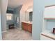 Bathroom featuring blue walls, a vanity, window seat, and a hexagonal tile floor at 6118 Yellow Birch Ct, Avon, IN 46123