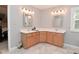 Bathroom with a double vanity, wood cabinets, a white countertop, and modern fixtures at 6118 Yellow Birch Ct, Avon, IN 46123