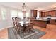 Traditional dining room featuring wooden table, hardwood floors, and natural light at 6118 Yellow Birch Ct, Avon, IN 46123