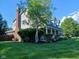 Charming two-story home with a brick chimney, beautiful landscaping, and a inviting front porch at 6118 Yellow Birch Ct, Avon, IN 46123