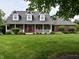 Charming red brick home featuring a welcoming front porch and meticulously maintained lawn, perfect for curb appeal at 6118 Yellow Birch Ct, Avon, IN 46123