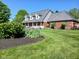 Inviting two-story home with manicured lawn, mature landscaping, and a covered front porch at 6118 Yellow Birch Ct, Avon, IN 46123