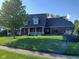 Charming home with well-manicured lawn, covered porch, and vibrant flower beds enhance curb appeal at 6118 Yellow Birch Ct, Avon, IN 46123