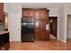Modern kitchen featuring stainless steel refrigerator, wooden cabinets, and hardwood flooring at 6118 Yellow Birch Ct, Avon, IN 46123