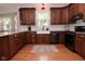 The kitchen features granite countertops, stainless steel appliances, tile backsplash and hardwood floors at 6118 Yellow Birch Ct, Avon, IN 46123