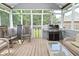 Relaxing screened porch area complete with wood flooring, grill, and outdoor seating arrangement at 6118 Yellow Birch Ct, Avon, IN 46123