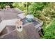 Aerial view of the roof featuring a rooftop deck with outdoor seating surrounded by mature trees at 6280 N Chester Ave, Indianapolis, IN 46220