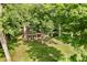 Aerial view of a brick home with a well-maintained lawn and plenty of mature trees, providing great shade at 6280 N Chester Ave, Indianapolis, IN 46220