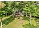 Aerial view of a charming brick home surrounded by lush greenery and mature trees, providing a sense of privacy at 6280 N Chester Ave, Indianapolis, IN 46220