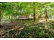 Exterior view of a home's backyard and screened porch, with lush green groundcover at 6280 N Chester Ave, Indianapolis, IN 46220