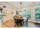 Bright breakfast nook with a round wooden table and plenty of natural light from the large windows at 6280 N Chester Ave, Indianapolis, IN 46220