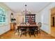Elegant dining room with hardwood floors, a large wooden table, and a decorative china cabinet at 6280 N Chester Ave, Indianapolis, IN 46220