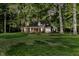 Charming brick home with a lush, green lawn and mature trees at twilight at 6280 N Chester Ave, Indianapolis, IN 46220