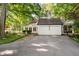 Exterior view of home with two-car garage featuring a cupola and a brick walkway leading to a charming covered porch at 6280 N Chester Ave, Indianapolis, IN 46220