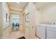 Hallway features laundry, light colored walls and views into other rooms at 6280 N Chester Ave, Indianapolis, IN 46220