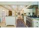 The kitchen has stainless appliances, granite counters and is adjacent to another living space at 6280 N Chester Ave, Indianapolis, IN 46220