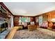 Traditional living room with wood paneling, brick fireplace and large oriental rug at 6280 N Chester Ave, Indianapolis, IN 46220