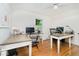 Bright office with hardwood floors, large windows, and multiple desks for a productive work environment at 6280 N Chester Ave, Indianapolis, IN 46220