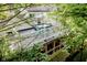 An inviting rooftop deck with a table and chairs offers a relaxing outdoor space surrounded by lush trees at 6280 N Chester Ave, Indianapolis, IN 46220